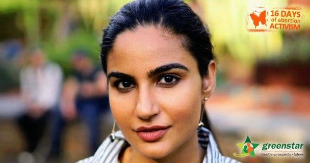 Young woman with a serious expression in focus, soft outdoor background. Text: "16 Days of Abortion Activism" and Greenstar logo in corners.